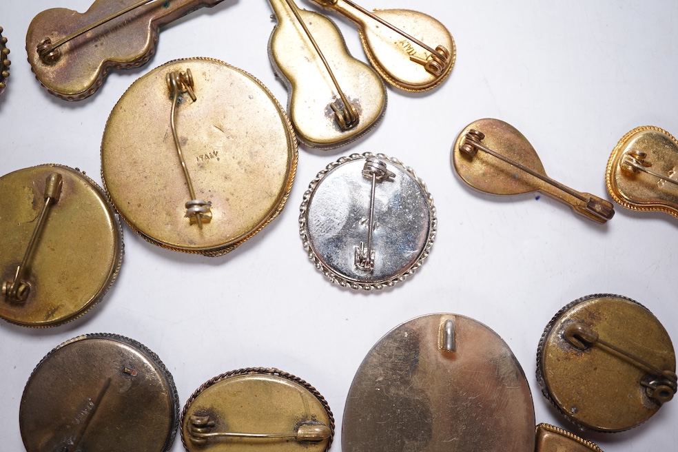 A collection of twenty-eight brooches, including fourteen mixed guitar and banjo shaped brooches, six large oval brooches, seven smaller brooches and one small oval., Condition - good